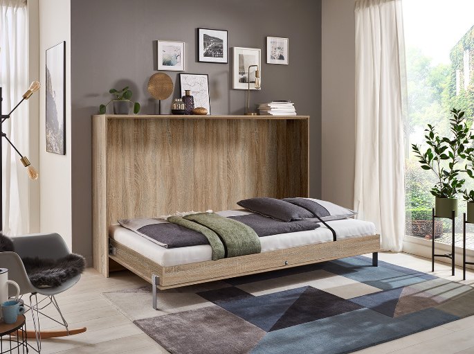 Couchage relevable déplié dans un séjour, caisson en décor chêne clair