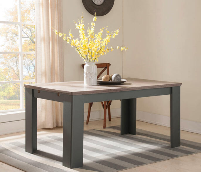 Table de salle &agrave; manger extensible en bois clair &agrave; pi&egrave;tement gris, dress&eacute;e dans une pi&egrave;ce lumineuse
